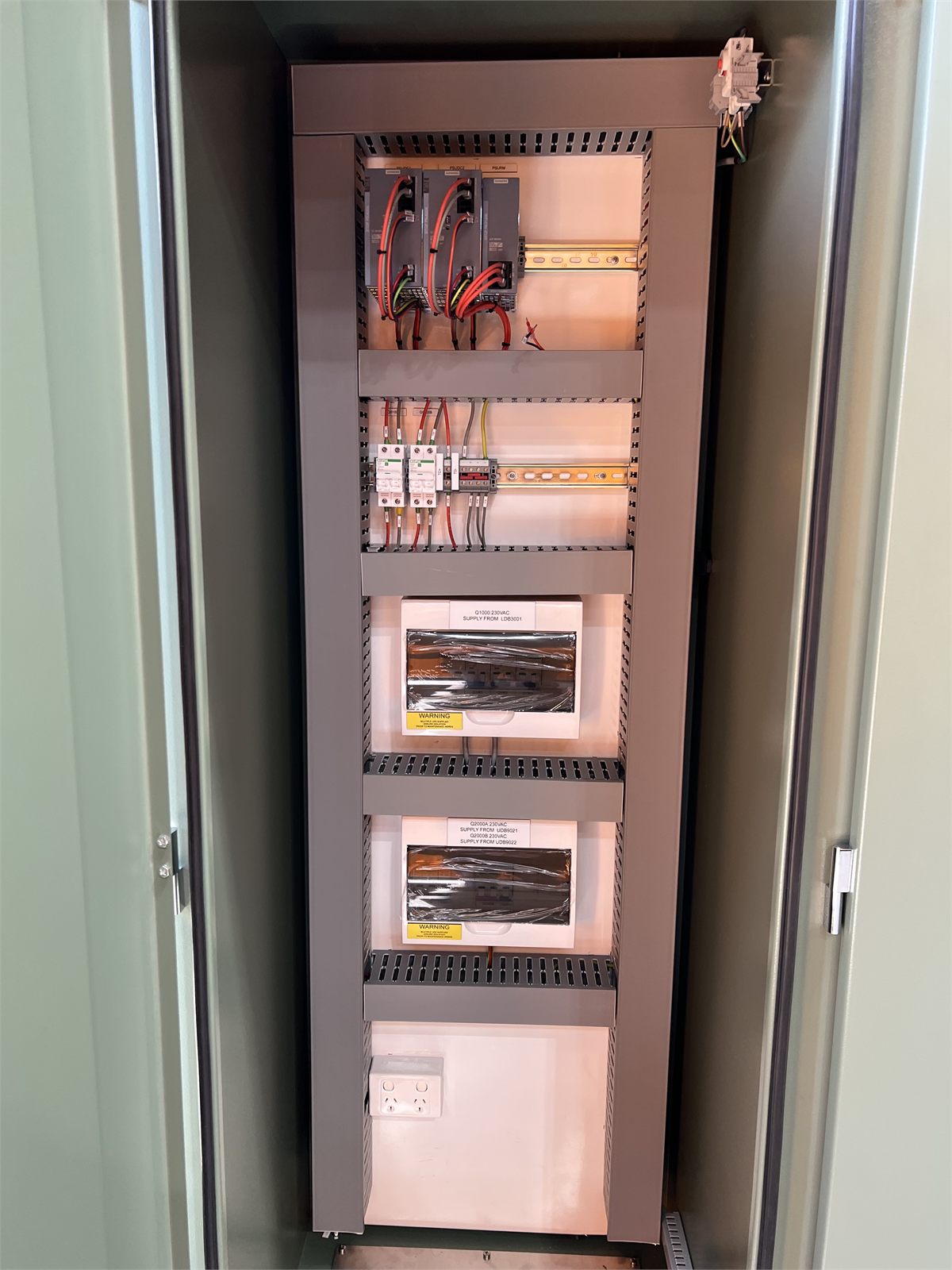 Internal power and control equipment inside a green control panel